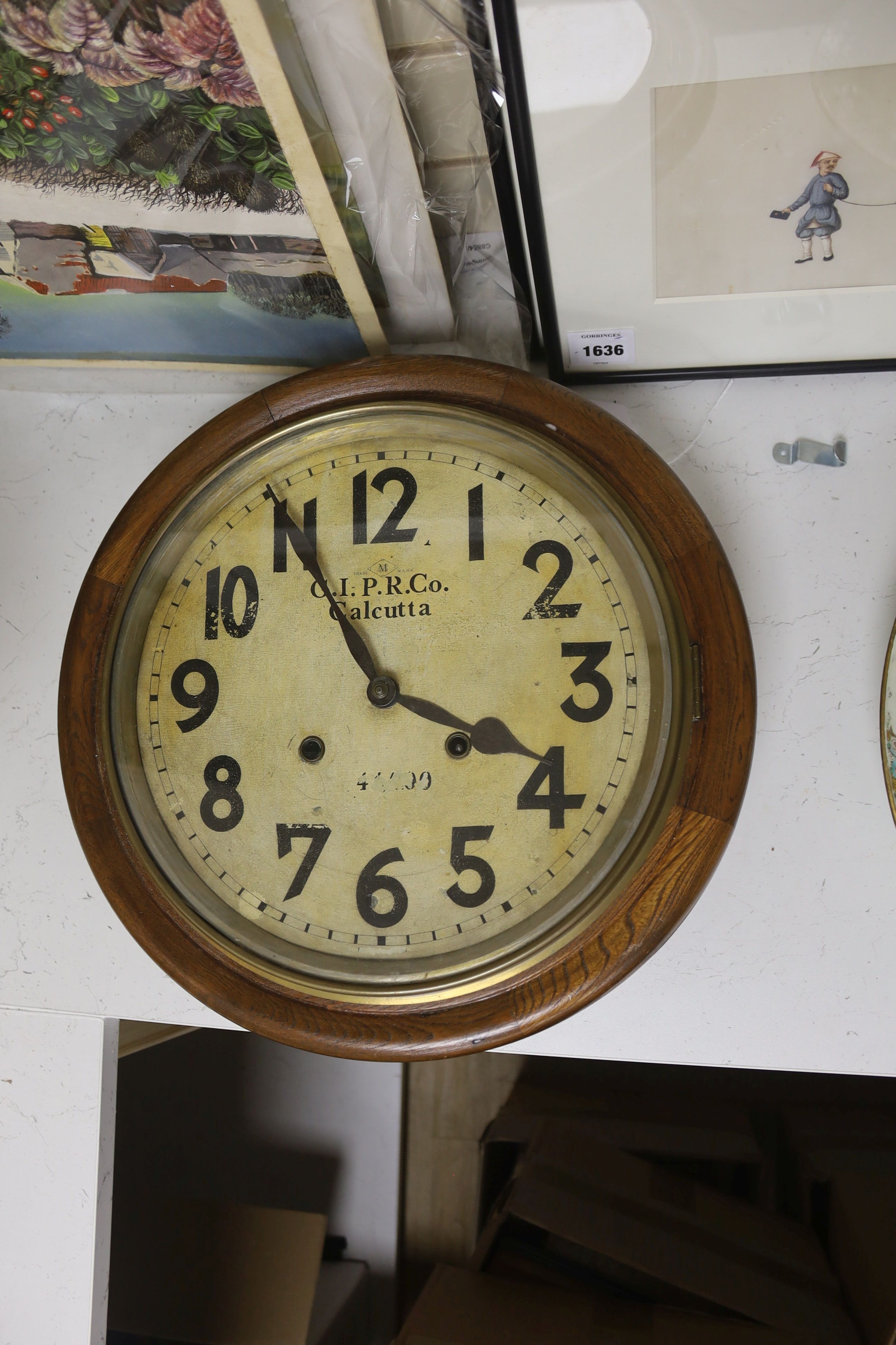 An early 20th century oak wall dial clock marked GIPR CO Calcutta, diameter 39cm